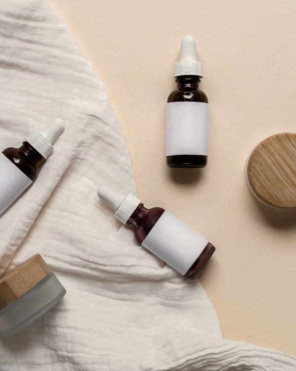 Amber dropper bottles on ivory linen