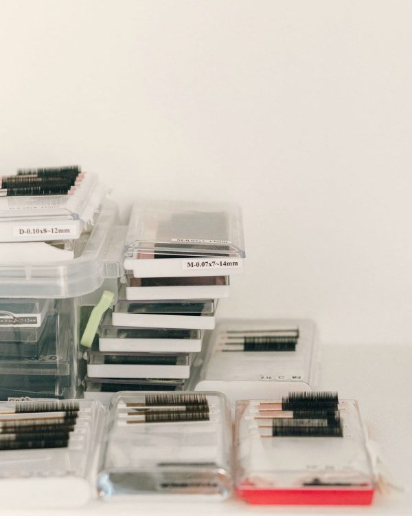 Stacked trays of Velvet Silk volume lashes in clear cases