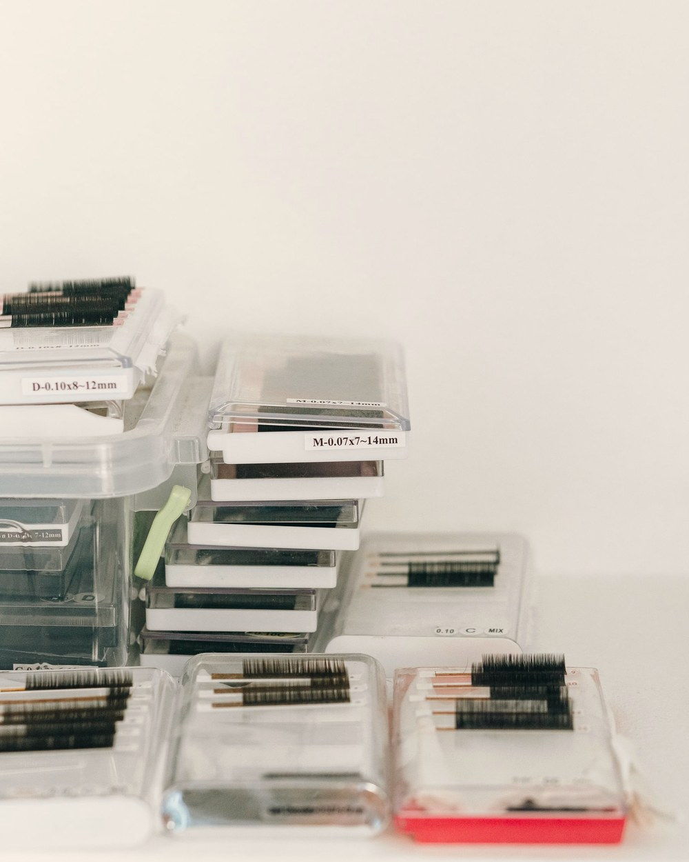 Stacked trays of Velvet Silk volume lashes in clear cases