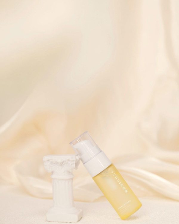 Ivory pump bottle on silk fabric